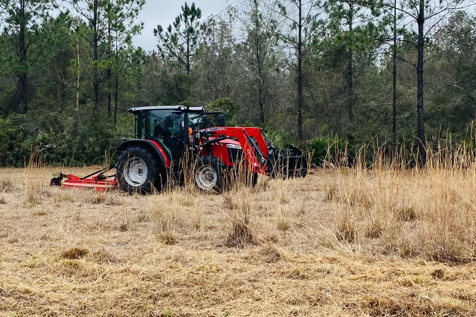 Rotary mowing along the edge of a grassy field
